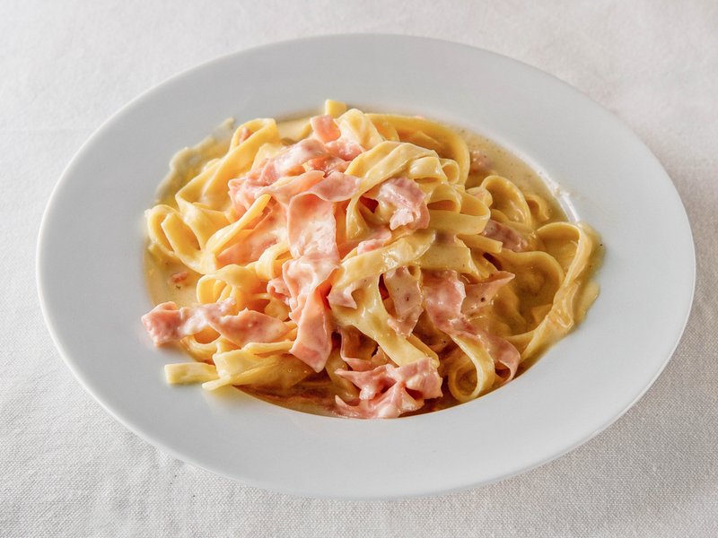 Tagliatelle carbonara: ribbons of pasta with ham in a creamy sauce